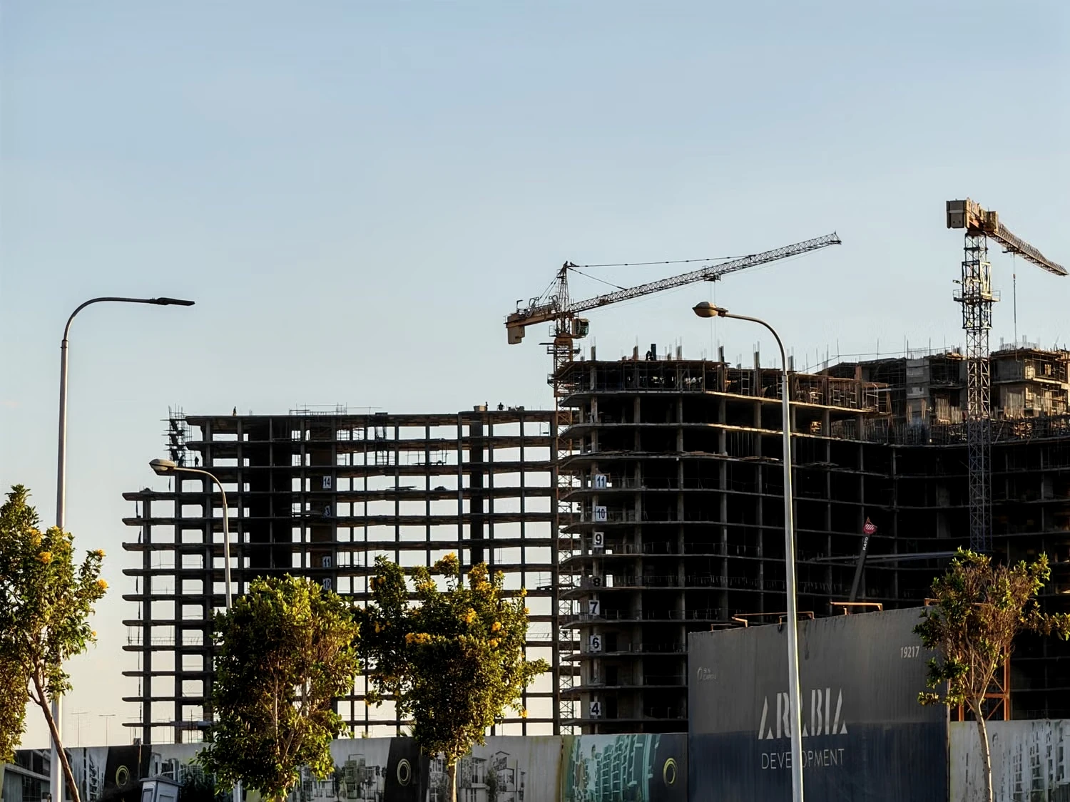 Building structure and tower cranes at a construction site